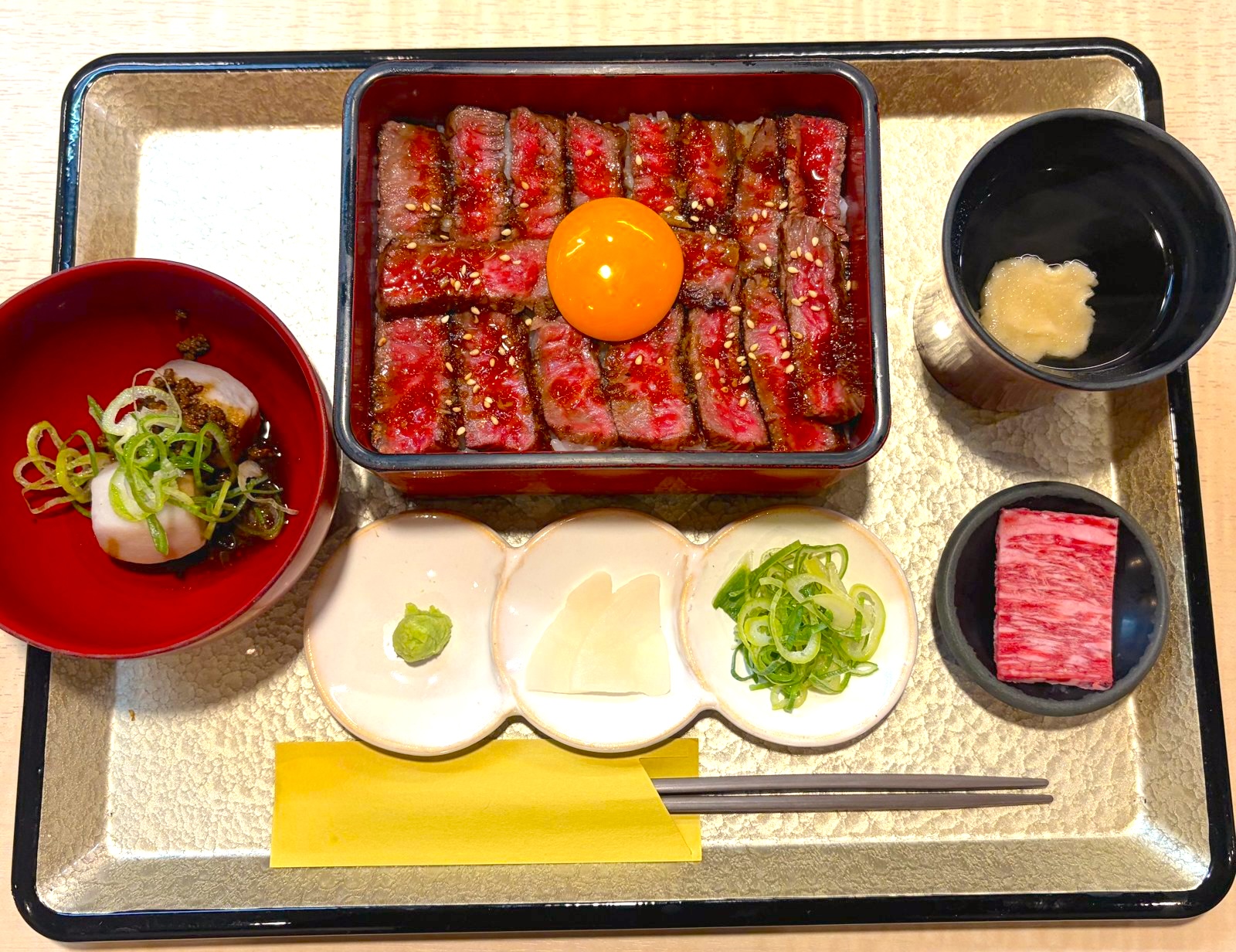 A5 wagyu steak box topped with a raw egg yolk, at MARE in Gion, Kyoto